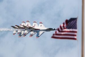 U.S. Airforce thunderbirds passing behind the american flag at the pier in Panama city Florida. The airshow was at the beach on May 5th, 2024.