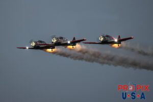 Titan Aerobatic team night performance at the 2025 Sun N Fun airshow in Lakeland Florida. #1 N791MH 1951 North American T-6 Texan. Mark Henley Team Lead #2 N3267G 1943 North American T-6 Texan. Bryan Regan Right Wing #3 N7462C 1958 North American T-6 Texan Steve Gustafson Left Wing Aircraft code: T6 Airport code(s): KLAL, LAL