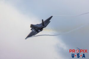 F-35 demonstrator was performing a low pass at the 2025 Sun N Fun airshow in Lakeland Florida. Clear contrails are seen forming on the wing leading edges and streaming seamlessly to the wingtips until they exit the aircraft body. Hot exhaust gases are also seen, as they visually distort the background. Aircraft code: F35 Airport code(s): KLAL, LAL