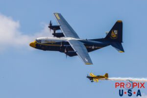 Mike and Albert.. Blue Angels' C-130 "Fat Albert" supply and transport aircraft performing a "Parade Pass" with N821MG (a 2009 Extra EA-300) piloted by Mike Goulian on it's left wingtip at the 2025 Augusta Georgia airshow. Fat Albert Flight Crew: Major Samuel Petko (USMC) Captain Isaac Becker (USMC) Major Josh Horman (USMC) Aircraft code(s): C130, E300 Airport code(s): KAGS, AGS