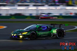 Money for nothin (and the chicks for free)..! Ferrari #021 metallic green pain is shimmering with a beautiful glow as the sun is just starting to cast light on the track in the early morning hours of the 2025 Rolex 24.