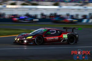 Been playing tag..? This Ferrari is rapidly accelerating after exiting the International Horseshoe. The cars approaching the turn in the background add a nice vibrance to the photo. This image was taken in the morning hours as the sun was just starting to illuminate the track at the 2025 Rolex 24 at Daytona.