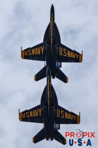 Pictured are two of the four aircraft flying in the "Trail Formation" (aircraft #1 and #2) as they cross over the crowd in preparation for the upcoming "Vertical Break". #1 Commander Adam Bryan (Commanding Officer) #2 Commander Jack Keilty (Right Wing) Aircraft code: F18 Airport code(s): KAGS, AGS