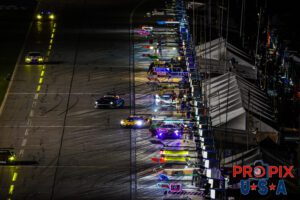 Rolex refreshment stand..! View of pit lane with some GTP and GTD cars in for service at night during the 2025 Rolex 24 at Daytona.