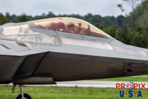 F-22 pilot waving the Shaka. F-22 Raptor Taxiing to the runway for the demonstration flight at the 2025 Brunswick Georgia airshow. The pilot can be seen waving the Hawaiian Shaka sign at the crowd. Aircraft code: F22 Airport code(s): BQK, KBQK Photo Date: 5-17-2025