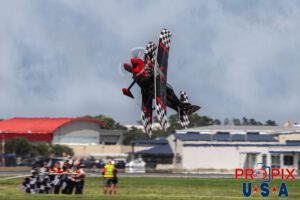 Just sayin hello..! Skip Stewart performs a super low altitude knife edge pass in his 2011 Pitts S-2 aircraft at the Sun N Fun airshow in Lakeland Florida, as guests of his wave at him from the airfield. Aircraft code: PTS2 Airport code(s): KLAL, LAL