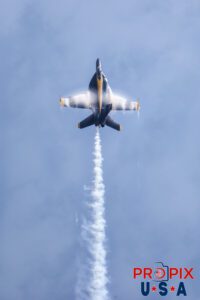 Coming from behind the spectator area at just above ground level, traveling at an ear ringing velocity near the speed of sound (around 690mph) Blue Angel #6 performs the "Sneak to Vertical Rolls" where he climbs almost instantly to 15,000' at the 2025 Augusta Georgia airshow. The ferocity and agressiveness of this maneuver is evidenced by the thickness of the vapor cloud forming around the aircraft. #6 Lieutenant Connor O'Donnell (opposing Solo) Aircraft code: F18 Airport code(s): KAGS, AGS