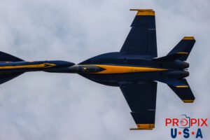 Blue Angels #5 and #6 performing the "Opposing Knife Edge" maneuver at the 2025 Brunswick Georgia airshow. LCDR O'Donnell can be seen looking to his "up" and watching CDR Zimmerman pass at a combined rate of approximately 920 mph. #5 Commander Thomas Zimmerman (Lead Solo) #6 Lieutenant Commander Connor O'Donnell (opposing Solo) Aircraft code: F18 Airport code: BQK (KBQK) Photo Date: 5-17-2025