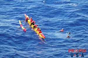 GET OUT..! The annual womens outrigger canoe race from Moloka'i to Waikiki beach Hawaii. Several miles off Oahu's coast, there was a scheduled paddler switch. Three of the crew dove off the boat and were quickly replaced with fresh arms. The crew swap was facilitated by a chase boat that followed the team for the entire crossing.