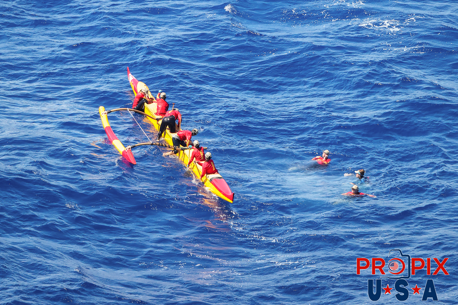 GET OUT..! The annual womens outrigger canoe race from Moloka'i to Waikiki beach Hawaii. Several miles off Oahu's coast, there was a scheduled paddler switch. Three of the crew dove off the boat and were quickly replaced with fresh arms. The crew swap was facilitated by a chase boat that followed the team for the entire crossing.