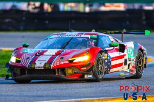 This Ferrari has shed it's red, white and green for red, white and blue..! The American Flag draped Ferrari is exiting the International Horseshoe at Daytona Speedway during the morning hours of the 2025 Rolex 24.