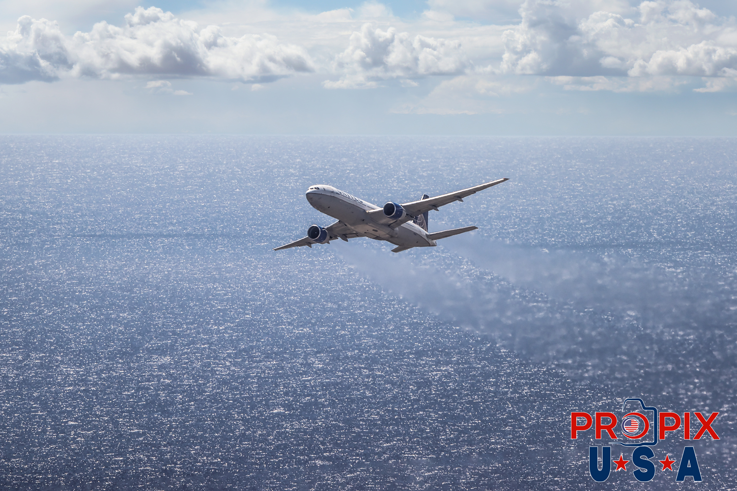 Time to Jet..! This a an unusual capture. What doesn't appear as a large aircraft is actually a Boeing 777 seconds after taking off from Honolulu's 8L runway. The exhaust gases are greatly distorting the ocean as it was passing. This image was captured as our helicopter was approaching the airport, which was following the H1 freeway as a typical air traffic route for local aircraft.