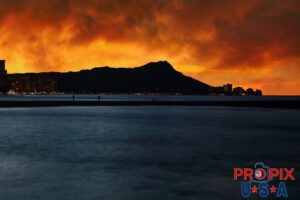 A spectacular sunrise is just beginning behind Diamondhead crater on Oahu Hawaii.