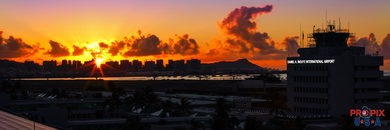 Honolulu International Airport's historic control tower with Diamondhead in the background and another spectacular sunrise is forming.