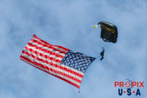 Parachutist bringing in the American flag "Old Glory" with the National Anthem being sung to kick off the days airshow at the 2017 Sun N Fun aviation event in Lakeland Florida.