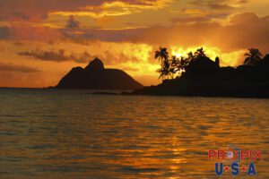 Kailua's fire in the sky. The beauty and intensity of the Hawaiian sun is perfectly captured in this image. One of the famous Moke Islands is seen in this view from Kailua Oahu towards Lanikai.