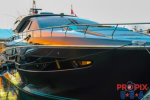 Reflection of the sunrise in the hull of a yacht.