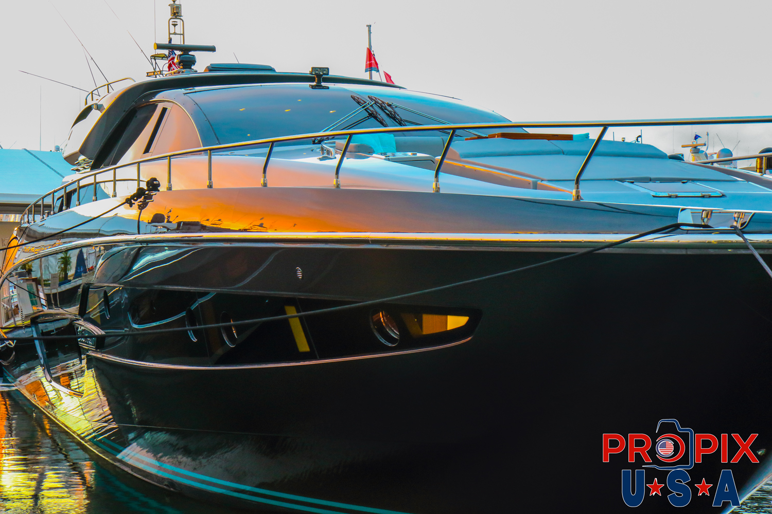 Reflection of the sunrise in the hull of a yacht.
