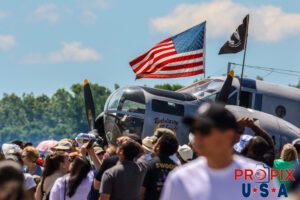 Crowd watching the airshow around a WWII war bird. N214CR 1958 Beech AT-11 On display at the 2024 Peachtree Dekalb airshow in Atlanta Georgia. Aircraft code: BE18 Airport code(s): PDK, KPDK Photo date: 5-11-2024