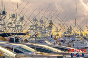 Small yachts and sport fishing boats docked as sunrise approaches.
