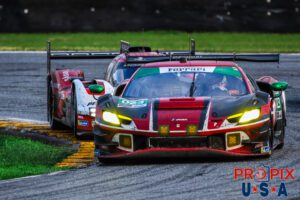 Get off my a**..! The Ferrari GTD contender is seen here with a mirror full of Penske Porsche in the infield section of the 2024 Rolex 24 hours at Daytona.