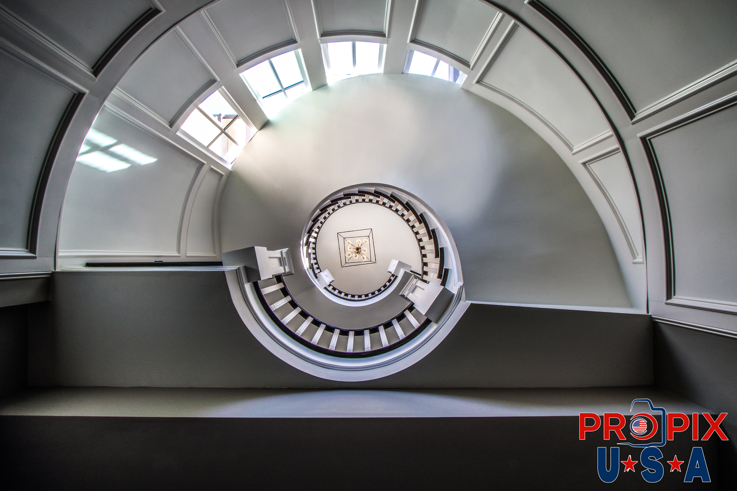 Looking up at three floors of round staircases