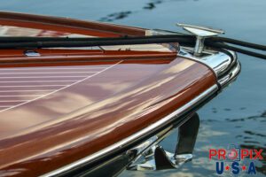 Bow of a docked mahogany boat.