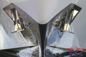 Bow of a yacht with polished chrome anchors.