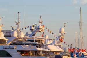 Sunrise on the aft decks of multiple mega yachts.