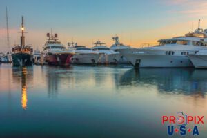 Light of fire..! Yachts docked at a marina at sunrise.