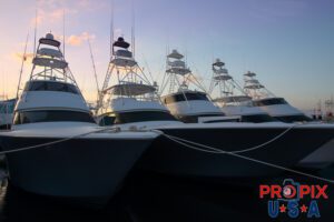 A row of sport fishing boats docked at sunrise.