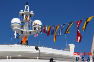 Colorful flags displayed atop a mega yacht.