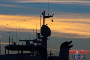 The mast of a yacht just before sunrise.
