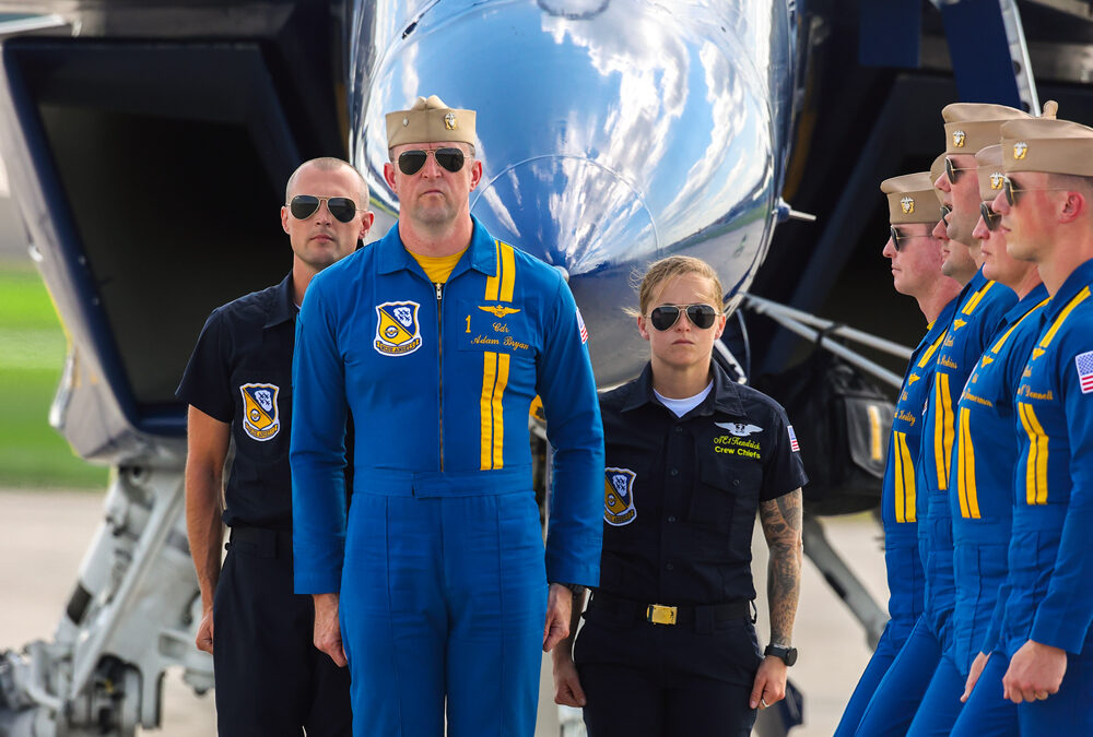Passing by to pick up the Boss..! Commander Bryan along with Petty Officers Alexander and Kendrick standing at attention as the five other Blue Angels pilots pass by aircraft #1 to complete their demonstration. #1 Commander Adam Bryan (Commanding Officer) #2 Commander Jack Keilty (Right Wing) #3 Major Brandon Wilkins (Left Wing) #4 Lieutenant Commander Wes Perkins (Slot) #5 Commander Thomas Zimmerman (Lead Solo) #6 Lieutenant Commander Connor O'Donnell (opposing Solo) Aircraft code: F18 Airport code(s): MQY, KMQY Photo date: 6-8-2025
