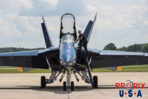 Keeping an eye out.. Petty Officer and #1 Crew Chief Chelsea Kendrick waits as Commander Adam Bryan prepares his equipment for the aerial demonstration at the 2025 Smyrna Tennessee air show. #1 Commander Adam Bryan (Commanding Officer) Aircraft code: F18 Airport code(s): MQY, KMQY Photo date: 6-8-2025