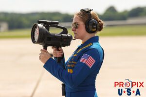 Showing the way home.. Blue Angels supply officer Lieutenant Mara Mason operates the light used by the pilots to identify show center from long distances at the 2025 Smyrna Tennessee air show. Airport code(s): MQY, KMQY Photo date: 6-8-2025
