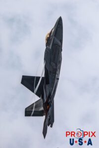 F-22 Raptor performing a vertical climb with afterburners engaged and contrails flowing past the aircraft at the 2025 Brunswick Georgia airshow. Aircraft code: F22 Airport code(s): BQK, KBQK Photo Date: 5-17-2025