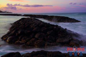 The lava rock sea walls creating the tidal pool at Ala Moana park Honolulu Hawaii.