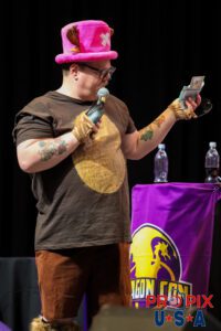 Dragon Con Masquerade 2025. Tony Gowell. Host with a handful of bribery money. Photo date: 8-31-2025 Dragoncon
