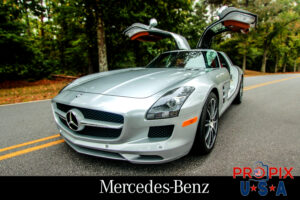 Mercedes Benz Corp. 2014 SLS AMG in Autumn with doors up in the fully open position.