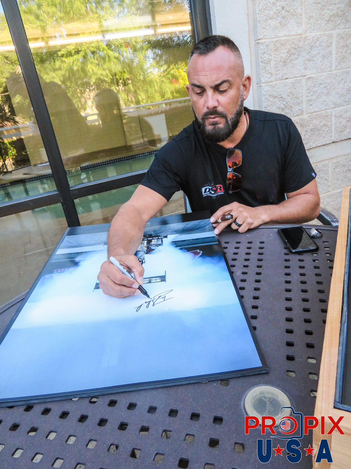NHRA 8x World Top Fuel champion Tony Schumacher signing / autograph burnout prints of his U.S Army dragster