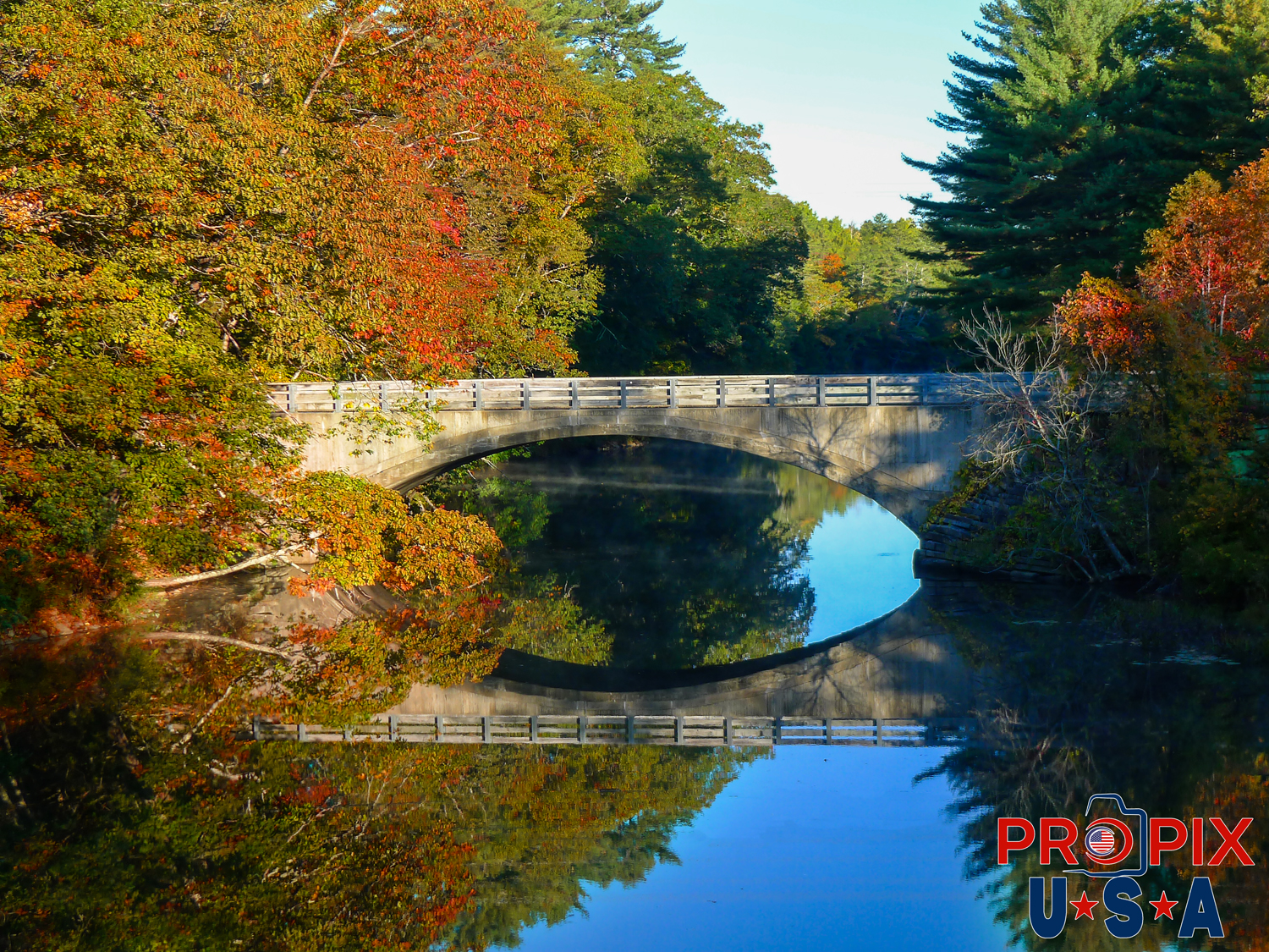 Maine bridge in Autumn with leaves in full color in morning Photo date: 10-1-2025