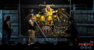 Nicko is seen having a laugh at Adrian when some pyrotechnics went haywire and made a stench on stage. Iron Maiden performing during The Book of Souls World Tour. Bruce Dickinson: Vocals Steve Harris: Bass guitar Nicko McBrain: Drums Adrian Smith: Guitar